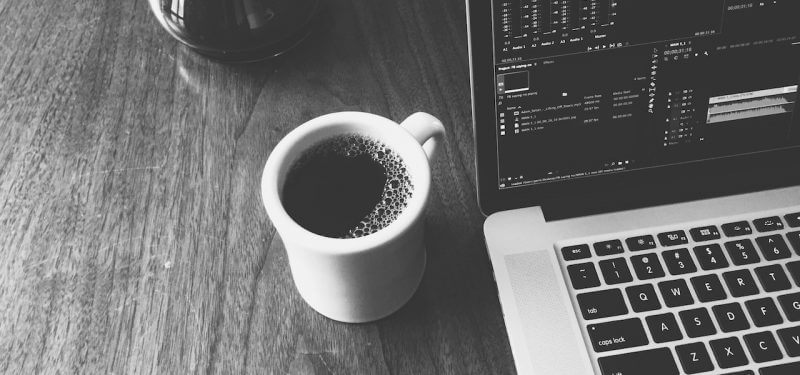 Coffee next to a laptop