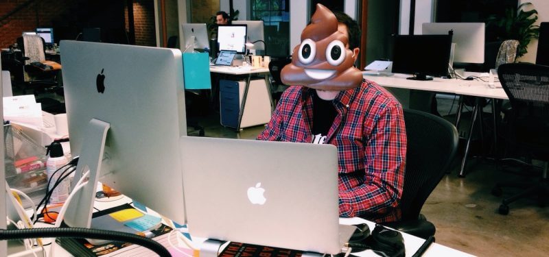 Developer with poop emoji mask on