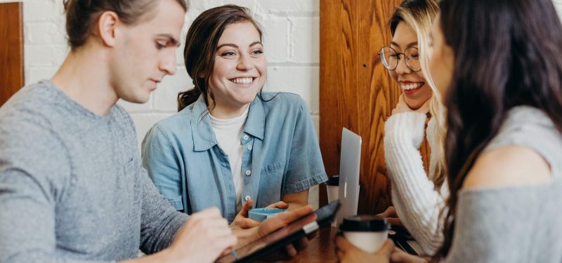 Group of students, studying, over coffee with technology