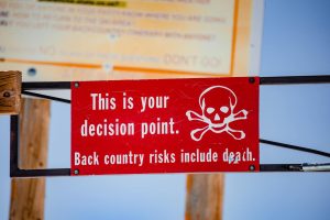 Red and white sign displayed at Snowmass, near Aspen, Colorado, warning of potentailly deadly concequences of going further.